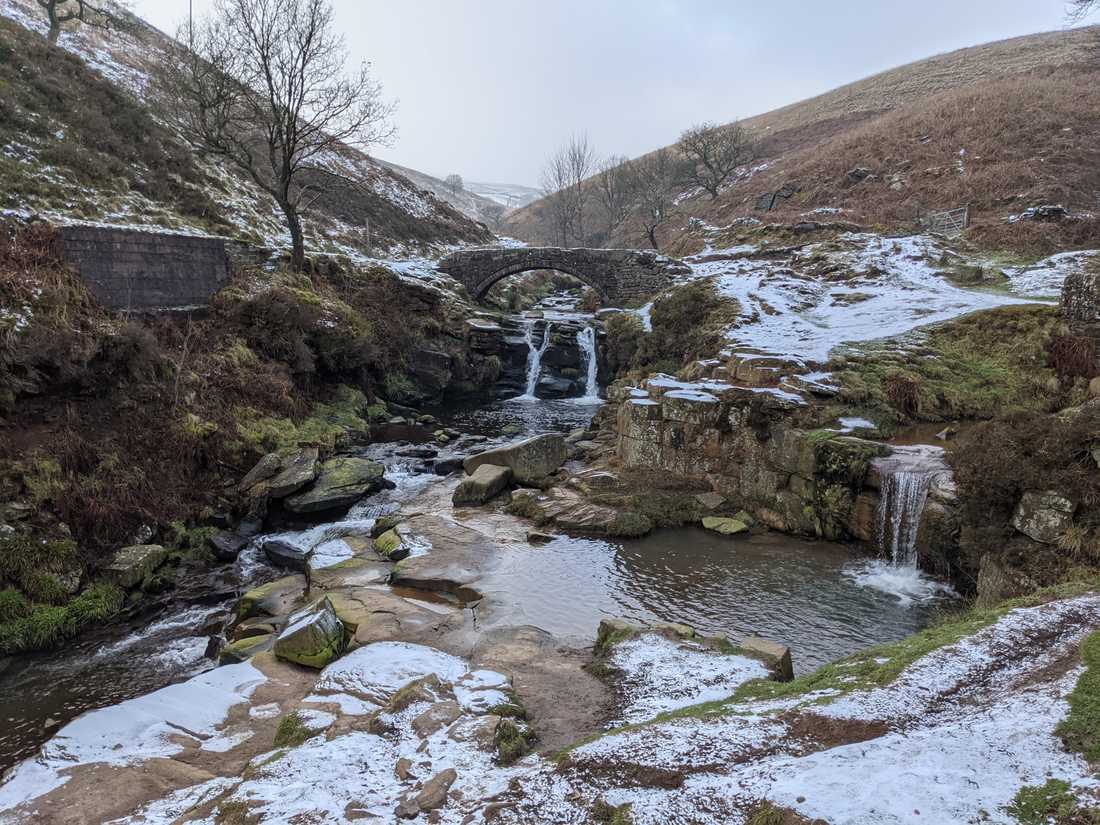 Three Shires Head with the packhorse bridge in the background